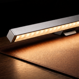 LED strip light on a brown leather surface with a dark background